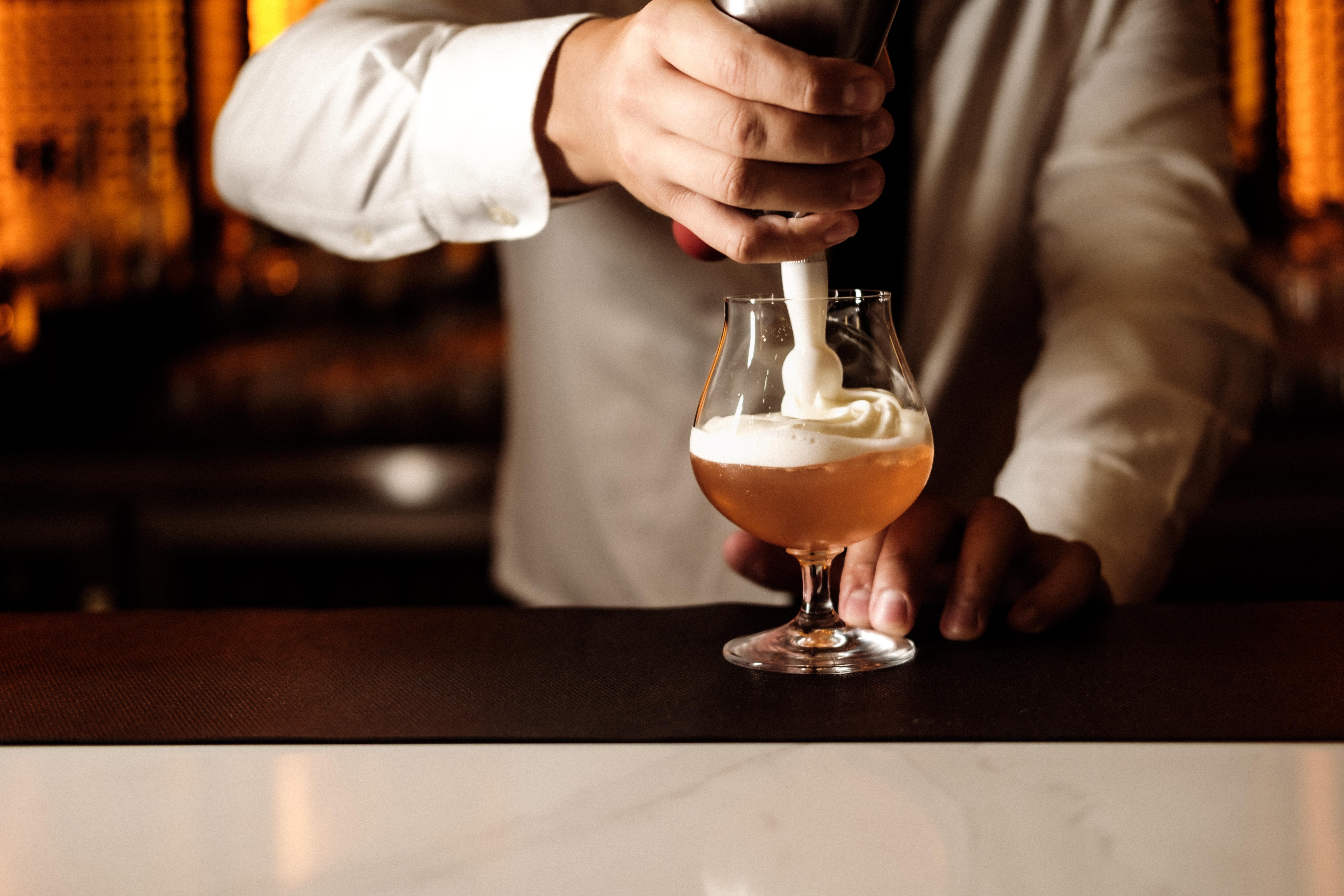 Intercontinental Malta By Ihg Hotel Saint Julian's Bagian luar foto A bartender mixing a cocktail